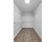 Spacious walk-in closet featuring wooden floors, bright lighting, and functional wire shelving at 4615 Reynosa Sw Dr, Winter Haven, FL 33880