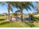 Relaxing hammock area with a tiki bar and tropical plants at 462 Lake View Way, Auburndale, FL 33823