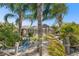 Tropical backyard retreat featuring a beach themed area, mature palms, and lounge seating at 462 Lake View Way, Auburndale, FL 33823