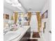 Well-lit bathroom featuring double sinks, a shower with a curtain, and neutral tones at 462 Lake View Way, Auburndale, FL 33823