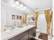 Bathroom with double sinks, decorative mirrors, and a shower with stylish curtains at 462 Lake View Way, Auburndale, FL 33823