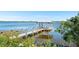 A beautiful dock with a gazebo extending into a calm lake, offering serene waterfront views at 462 Lake View Way, Auburndale, FL 33823