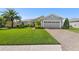 Charming single Gathering home features lush landscaping, brick driveway, and a two-car garage at 462 Lake View Way, Auburndale, FL 33823
