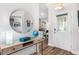 Bright foyer with wood floors, stylish console table, and decorative mirror at 462 Lake View Way, Auburndale, FL 33823