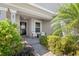 Inviting front porch with seating area, beautiful landscaping, and stylish entrance at 462 Lake View Way, Auburndale, FL 33823
