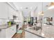 Well-lit kitchen featuring white cabinets, stainless steel appliances, granite countertops, and wood flooring at 462 Lake View Way, Auburndale, FL 33823