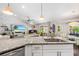 Modern kitchen featuring granite countertops with breakfast bar overlooking the living area at 462 Lake View Way, Auburndale, FL 33823
