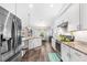 Spacious kitchen with stainless steel appliances, white cabinets, and a cozy dining area at 462 Lake View Way, Auburndale, FL 33823
