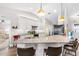 Bright kitchen with white cabinets, granite countertops, stainless appliances, and pendant lighting at 462 Lake View Way, Auburndale, FL 33823