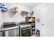 Laundry area featuring modern washer and dryer, shelves, and storage at 462 Lake View Way, Auburndale, FL 33823