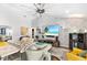 Cozy living room with large fan and TV at 462 Lake View Way, Auburndale, FL 33823