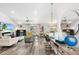 Bright living room features wood floors, ceiling fan and an entertainment center at 462 Lake View Way, Auburndale, FL 33823