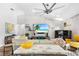 Living room boasts vaulted ceilings, brick accent wall and a ceiling fan at 462 Lake View Way, Auburndale, FL 33823