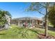 Screened in pool area with a garden, a small outdoor shed and tropical plants at 462 Lake View Way, Auburndale, FL 33823
