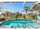 Inviting screened-in pool with walk-in steps and lush landscaping is perfect for recreation at 462 Lake View Way, Auburndale, FL 33823