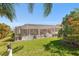 Screened in pool area with manicured lawn and tropical foliage at 462 Lake View Way, Auburndale, FL 33823