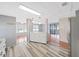 An open kitchen flows into living area with wood floors and modern lighting at 5091 Fox Cliff Dr, Lakeland, FL 33810