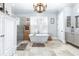 Bright bathroom featuring a soaking tub, walk-in shower, stone floors, and wooden accents at 5100 Homeland Garfield Rd, Bartow, FL 33830