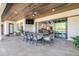 Inviting covered patio with dining space, ceiling fan, and seamless transition to the interior living areas at 5100 Homeland Garfield Rd, Bartow, FL 33830