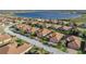 Aerial view of a residential neighborhood by the lake, with lush green lawns and manicured landscaping at 5556 Hogan Ln, Winter Haven, FL 33884