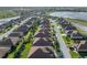 Aerial view of a well-maintained neighborhood with lush green lawns, sidewalks, and mature palm trees at 5556 Hogan Ln, Winter Haven, FL 33884