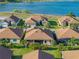 Aerial view highlighting single-Gathering homes with screened patios, lush landscaping, and lake views in this charming community at 5556 Hogan Ln, Winter Haven, FL 33884