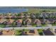 An aerial shot highlights this single-Gathering home's landscaping, curb appeal, and community lake access at 5556 Hogan Ln, Winter Haven, FL 33884