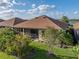 Aerial view of the backyard highlighting the screened-in patio, landscaping, and proximity to a lake at 5556 Hogan Ln, Winter Haven, FL 33884