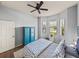 Bright bedroom with a charming blue dresser and large windows at 5556 Hogan Ln, Winter Haven, FL 33884