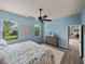 Bright bedroom with lots of natural light, blue accents, and a ceiling fan at 5556 Hogan Ln, Winter Haven, FL 33884