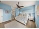 A charming bedroom features a decorative bed, blue accent wall, and coordinating nightstands at 5556 Hogan Ln, Winter Haven, FL 33884