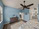 Comfortable bedroom with a television, ceiling fan, and ensuite bathroom at 5556 Hogan Ln, Winter Haven, FL 33884