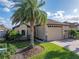 View of the home's exterior showcasing a large garage and lush landscaping with a beautiful brick driveway at 5556 Hogan Ln, Winter Haven, FL 33884