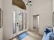 Bright foyer featuring tiled floors, a decorative front door, and a view into the home at 5556 Hogan Ln, Winter Haven, FL 33884