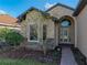 Inviting front entrance with an arched window over the door and decorative stone accents at 5556 Hogan Ln, Winter Haven, FL 33884