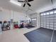 Garage with epoxy floor, overhead lighting, and shelving for efficient storage at 5556 Hogan Ln, Winter Haven, FL 33884