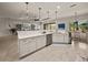 Bright kitchen featuring quartz countertops, stainless appliances, and eat-in bar at 5556 Hogan Ln, Winter Haven, FL 33884