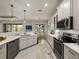 Modern kitchen featuring stainless steel appliances and quartz countertops at 5556 Hogan Ln, Winter Haven, FL 33884