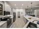 Modern kitchen with white cabinets, quartz countertops, and stainless steel appliances at 5556 Hogan Ln, Winter Haven, FL 33884