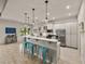 Open concept kitchen featuring an island with seating and stainless steel appliances at 5556 Hogan Ln, Winter Haven, FL 33884