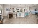 Bright living area seamlessly blends with a modern kitchen featuring bar seating for casual dining at 5556 Hogan Ln, Winter Haven, FL 33884