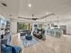 Spacious open-concept living room and kitchen with tile floors, modern furnishings, and plenty of natural light at 5556 Hogan Ln, Winter Haven, FL 33884