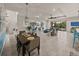 Open-concept living room, dining, and kitchen area with tile flooring and ample natural light at 5556 Hogan Ln, Winter Haven, FL 33884