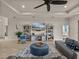 Relax in this living room with neutral decor, a large fan, and beautiful tile flooring at 5556 Hogan Ln, Winter Haven, FL 33884