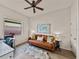 A bonus room showcasing natural light, leather sofa, and world map wall art, perfect for an office at 5556 Hogan Ln, Winter Haven, FL 33884