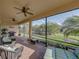 Relaxing screened-in patio with comfortable seating, grill, ceiling fans and a backyard view at 5556 Hogan Ln, Winter Haven, FL 33884