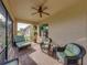 Relaxing screened-in patio with comfortable wicker seating and a ceiling fan for those warm days at 5556 Hogan Ln, Winter Haven, FL 33884