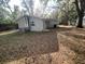 Back exterior view of the home featuring HVAC and back entry at 626 N Nashua Ave, Fort Meade, FL 33841