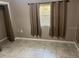Compact bedroom with tile flooring and well-lit by a single window at 626 N Nashua Ave, Fort Meade, FL 33841