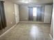 Bedroom features neutral walls, tile flooring, and natural light from a window at 626 N Nashua Ave, Fort Meade, FL 33841